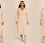 Woman wearing a plus-size cashmere sweater dress in a oatmeal color.