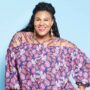 A woman wearing a plus size outfit with a flowy, floral patterned top